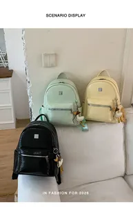 Three stylish woven texture backpacks in black, green, and yellow on a white sofa