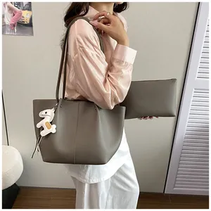 Elegant grey pebbled leather tote bag with matching pouch and white horse charm detail
