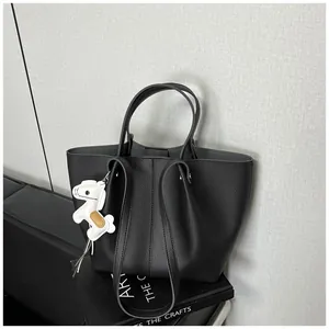 Premium black litchi pattern tote bag featuring a cute white horse charm on a book