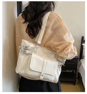 Back view of a stylish cream large capacity tote bag with trendy buckle details on a model.