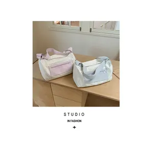 Two pastel nylon pillow bags with star patterns displayed on a minimalist wooden desk