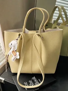 Yellow pebble leather tote bag with dog charm for women large capacity commuter style