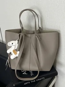 Elegant grey pebbled leather tote bag with a white horse charm for daily commute