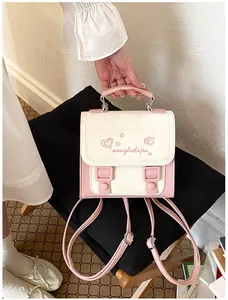 Detailed view of a small pink and cream aesthetic backpack with delicate heart embroidery