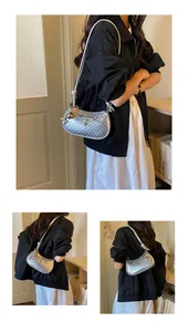 Detailed views of a chic silver underarm bag with bow and polka dot cutout design