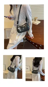 Stylish black and white polka dot shoulder bag with bow detail and silver balloon dog charm