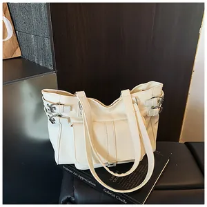 Detailed view of stylish white large capacity commuter tote bag with buckle accents