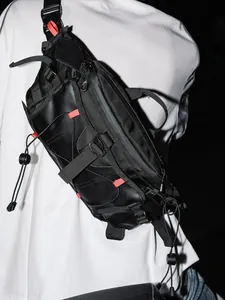 Black tactical crossbody bag with functional straps and red accents for urban techwear style.