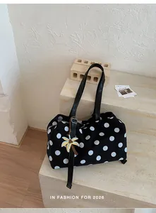 Close-up detail of black large capacity polka dot tote bag with cute palm tree charm