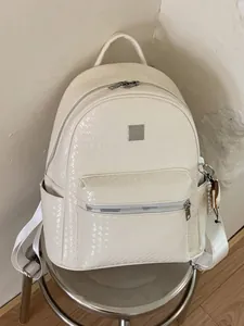 Stylish cream woven backpack for women with large capacity and elegant charm pendant