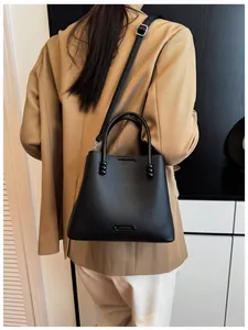 Detailed shot of a stylish black leather bucket bag with pebble grain texture