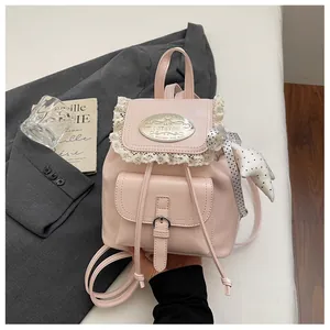 Detailed close-up of a stylish retro pink mini backpack with lace trim and star charm