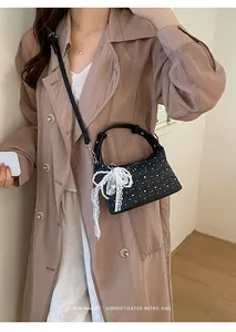 Retro grid crossbody bag with pearl lace charm shown on model in trench coat