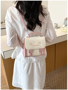 Detailed back view of a stylish pink and cream mini backpack for women's summer commute