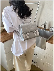 Back view of woman wearing a stylish silver backpack in a modern kitchen