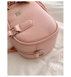Close-up of pink pebbled leather bowling bag with silver zipper and hardware detail.