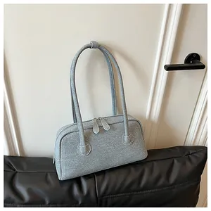 Close-up detail of grey textured fabric on a stylish commuter Boston pillow handbag