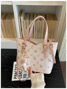 Detailed shot of a pink patterned bucket bag with a cute bear charm in a lifestyle setting