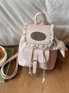 Elegant vintage pink mini backpack for women featuring delicate lace trim and star charm