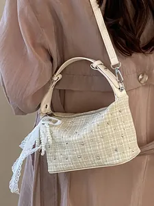 Elegant cream plaid handbag with studs and lace charm, versatile crossbody bag for women