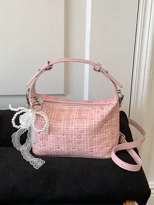 Stylish pink checkered tweed handbag featuring rhinestone studs and a pearl lace bow charm