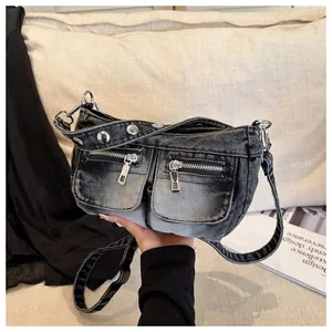 Retro wash denim crossbody bag with double front zip pockets and silver hardware