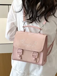 Trendy pink women's backpack featuring elegant heart embroidery and suede texture finish