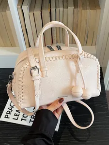 Elegant light pink pebbled leather Boston handbag for women with adjustable crossbody strap