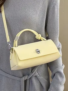 Minimalistische hellgelbe Leder-Umhängetasche mit Knotengriff und silbernem Verschluss