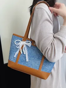 Large denim tote bag with brown leather trim, white lace bow and pearl charms for women