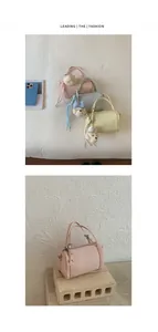Detailed macro view of the mini pink cylindrical handbag with a cute plush bear charm