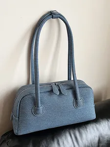Blue denim-textured Boston pillow bag with long shoulder straps for women
