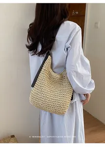 Détail d'un grand sac cabas en paille tressée pour les vacances à la plage en été.