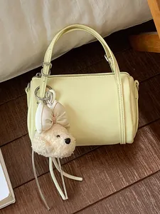 Elegant cream yellow cylindrical pillow handbag with cute plush poodle keychain charm