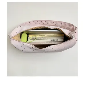 Spacious pink polka dot tote bag interior showing capacity for laptop and multiple books