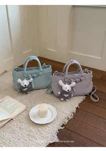 Elegant pastel leather handbags with cute bunny charms for versatile daily wear.