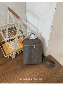 Detail view of gray vintage bucket bag in a stylish lifestyle setting
