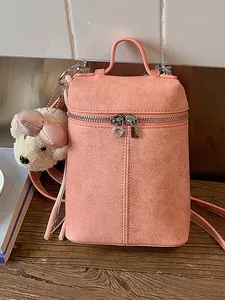 Stylish minimalist pink crossbody bucket bag for women with a cute plush bear charm