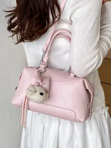 Elegant pink Boston bag with a cute plush puppy charm for stylish daily commute