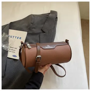 Detail view of a brown canvas barrel crossbody bag featuring MuLanKou branding