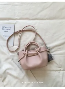 Detailed view of the pebbled texture on a pink bucket bag for women.