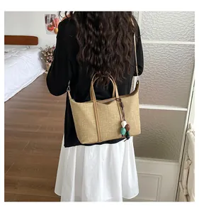 Large capacity woven tote bag shown on a model in a cozy indoor lifestyle setting