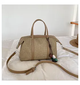 Modern casual canvas shoulder bag for women featuring a unique decorative bead tassel charm