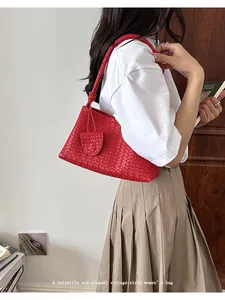 Elegant red woven leather shoulder bag detail with minimalist vintage aesthetics