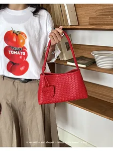 Elegant red woven underarm bag featuring a vintage style and intricate pattern detail