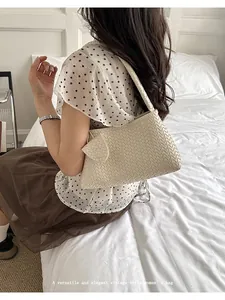 Detail view of elegant beige woven leather underarm bag for women in vintage style