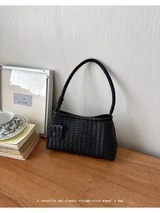 Elegant black woven hobo bag for women with vintage-style texture and matching strap