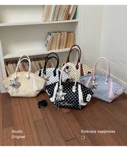 Detailed shot of various polka-dot nylon tote bags in a lifestyle setting