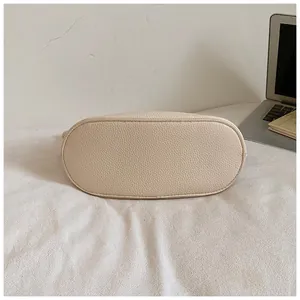 Primo piano del fondo in pelle martellata testurizzata di una borsa casual crema