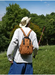 Detailed view of lightweight brown nylon backpack for outdoor hiking and commuting